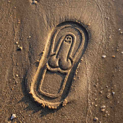 Detailed close-up of the Soleprint pattern pressed into beach sand